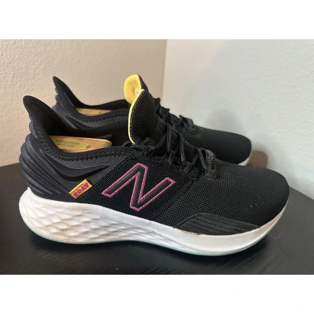 New Balance Black Athletic Sneakers with Pink and Yellow Accents